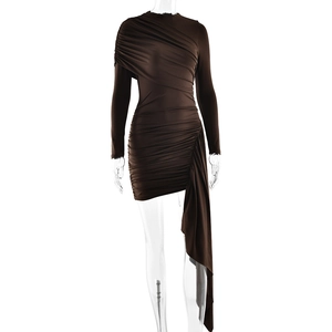 Close-up of brown bodycon dress featuring pleated details and asymmetrical hemline
