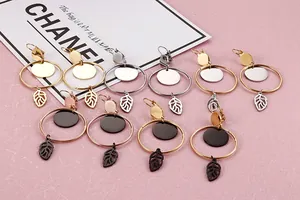 Close-up of geometric hoop earrings with metal sequins and hollow leaf charms in five colors