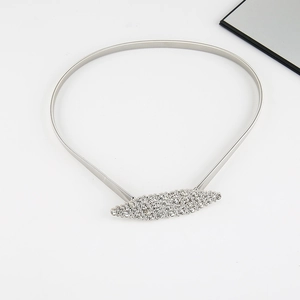 Detail of silver leaf rhinestone buckle on elastic metal spring belt for dresses