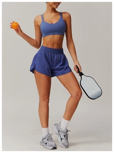 Detail of blue-purple two-piece yoga set with cross back sports bra and high waist shorts