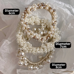 Detailed view of pearl hair scrunchies in 6cm, 7cm and 8cm diameters with crystal inlay