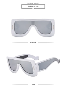 Close-up of futuristic silver shield sunglasses showing front and side profile views