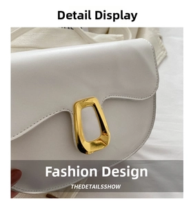 Detail of white PU leather saddle bag with gold geometric buckle and curved flap