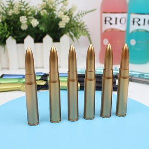Detail view of six gold bullet-shaped erasable gel pens with metallic finish on blue surface