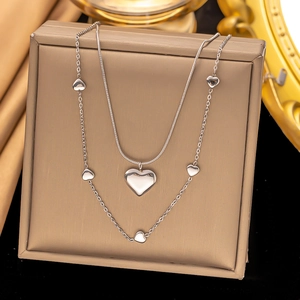 Double-layered silver heart necklace featuring a sleek snake chain and pendant charms