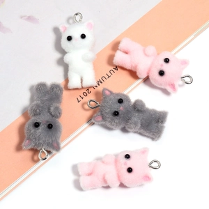 Detailed view of flocked 3D cat charms in white, pink, and grey with silver loops