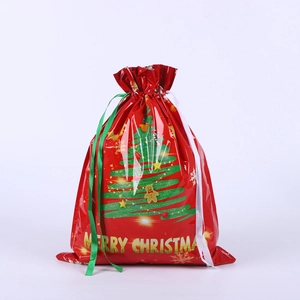 Detail of red Christmas drawstring gift bag with gingerbread man and tree prints