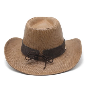 Close-up of brown woven cowboy straw hat featuring a decorative band and bow detail