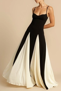 Detail of a color-block long dress with thin straps and a flowing black and white skirt
