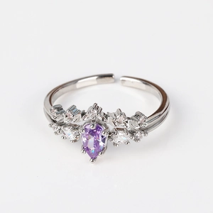 Detail of 18K silver adjustable ring featuring a pear-cut purple zircon crown design