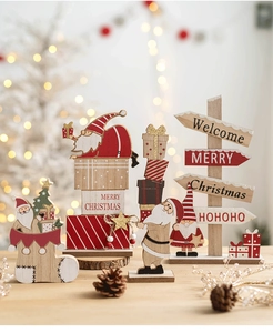 Detail of Christmas wooden ornaments with Santa Claus and gifts in warm bokeh lighting