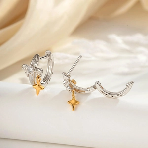 Minimalist silver hoop earrings with gold star pendants and sparkling crystal stones