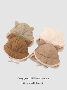 Close-up of heart-quilted winter hats for kids with ear flaps and plush lining in four colors