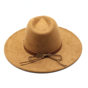 Detail of camel wool felt fedora featuring a slim brown leather band and bow tie detail