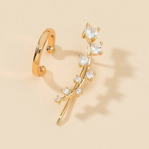 Detail of gold ear cuff featuring a delicate branch leaf design with clear zircon stones
