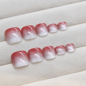 Sparkling cat-eye press-on toenails featuring red and silver gradient glitter effect