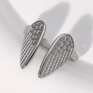 Detailed close-up of adjustable silver wing ring with fine feather texture in stainless steel