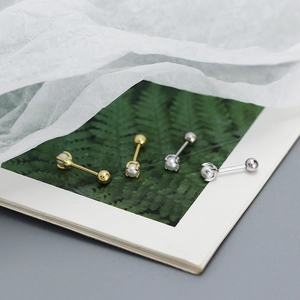Detailed macro view of gold and silver S925 sterling silver pearl stud earrings