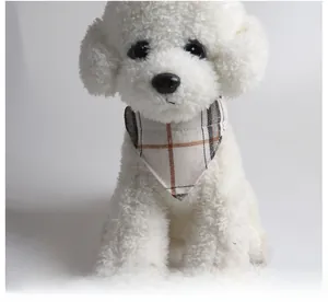 Close-up of classic plaid dog bandana in brown and white on a plush puppy model