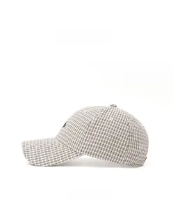 Side view of checkered baseball cap with black letter embroidery and fine grid pattern