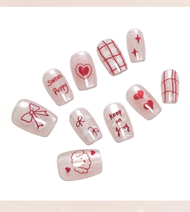 Close-up of cat-eye press-on nails featuring sweet puppy and red heart patterns