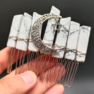 Detail of handmade silver hair comb with natural white stone crystals and moon star charms