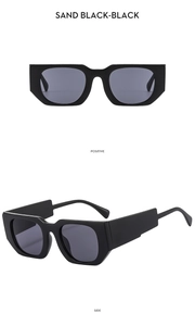Detail view of square sand black sunglasses with wide temples and dark lenses