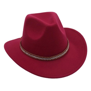 Detail of burgundy wool fedora hat featuring a studded brown faux leather band decorative