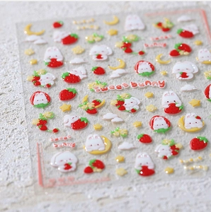 Macro view of 3D embossed rabbit and strawberry nail stickers with sweet texture