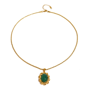 Detail view of oval green gemstone pendant with golden twisted rope chain and lobster clasp