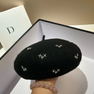 Detail of silver star rhinestones on a black fleece beret with elegant gift box
