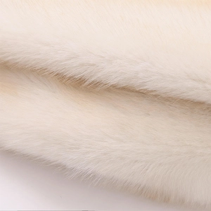 Close-up of soft faux fur texture in cream white showing plush fiber and premium material