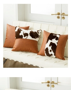 Detail of cow print faux fur and brown leather patchwork decorative throw pillows
