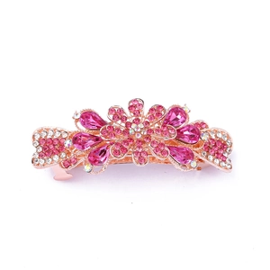 Detail of rose gold alloy hair clip with pink and clear crystals in floral leaf shape