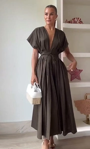 Detailed view of deep olive maxi dress with V-neckline and elegant pleated waist tie