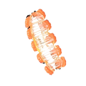 Macro view of a translucent orange pumpkin hair claw clip made of durable acrylic material