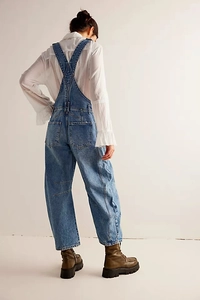 Rear view of vintage blue denim dungarees with cross-back straps and large cargo pockets