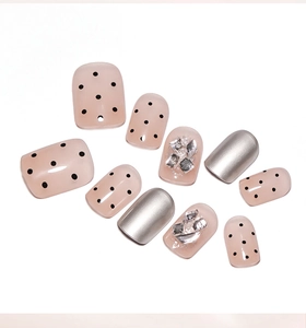 Detail of nude polka dot, silver mirror, and glitter diamond press-on nail set