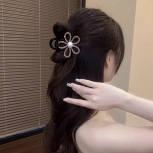 Elegant flower hair claw clip with rhinestones and pearl on hair back view