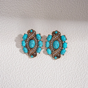 Détails de boucles d'oreilles vintage en or avec résine turquoise et strass brillants
