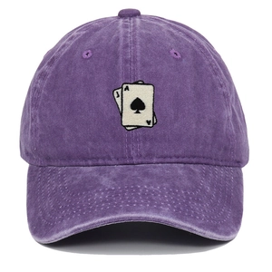 Macro detail of playing cards embroidery on a vintage washed purple baseball cap