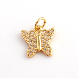 Close-up of a gold butterfly pendant with micro-pave zircons for DIY jewelry making