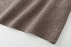 Close-up of premium tan knit fabric showing soft texture and detailed weaving pattern