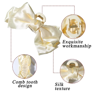 Detail view of satin bow hair claw showing silk texture and strong metal spring