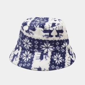 Close-up of warm navy plush bucket hat featuring white reindeer and snowflake patterns