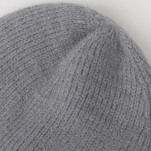 Close-up of the soft knit texture and dark grey wool fibers on this warm winter beanie