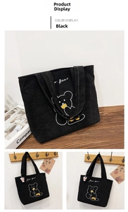 Detail of black corduroy tote bag with bear embroidery and cow plush charm pendant