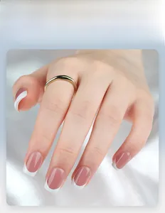 Detail of short French tip press-on nails with nude pink base and white edges