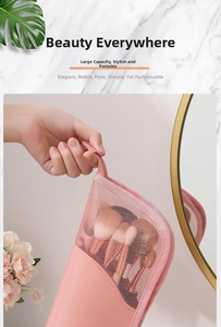 Pink mesh and leather makeup brush case showing spacious interior storage and zipper