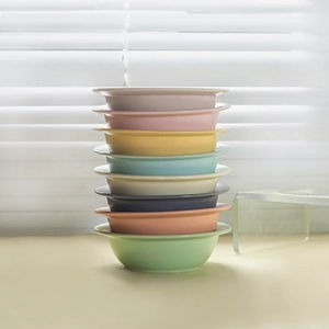 UFO-shaped ceramic pet bowl set with stacked colorful bowls and acrylic stand